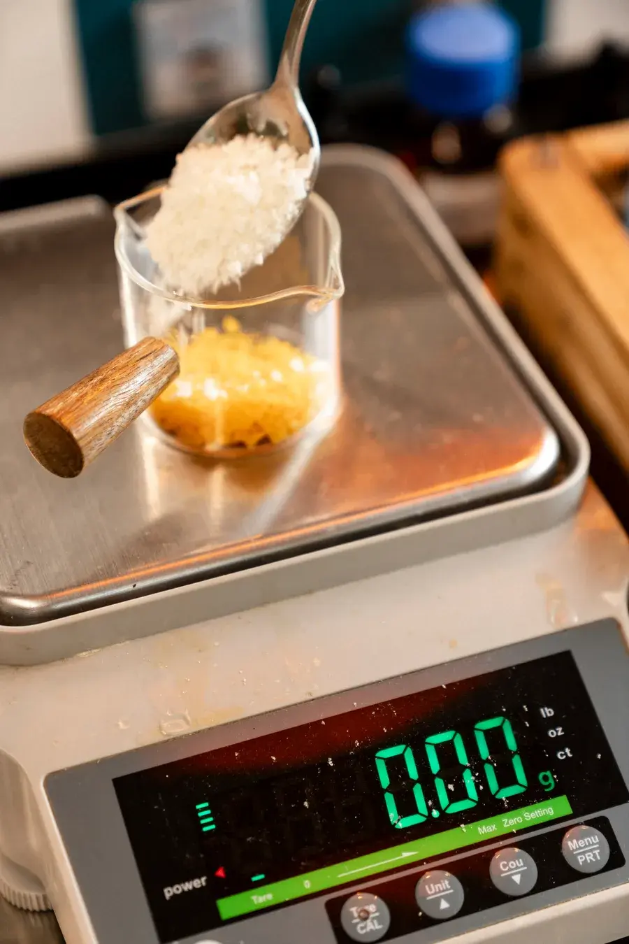 Balm workshop Phuket — weighing natural wax ingredients on lab scale